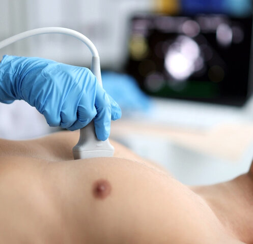 Doctor performs chest ultrasound on man in hospital closeup